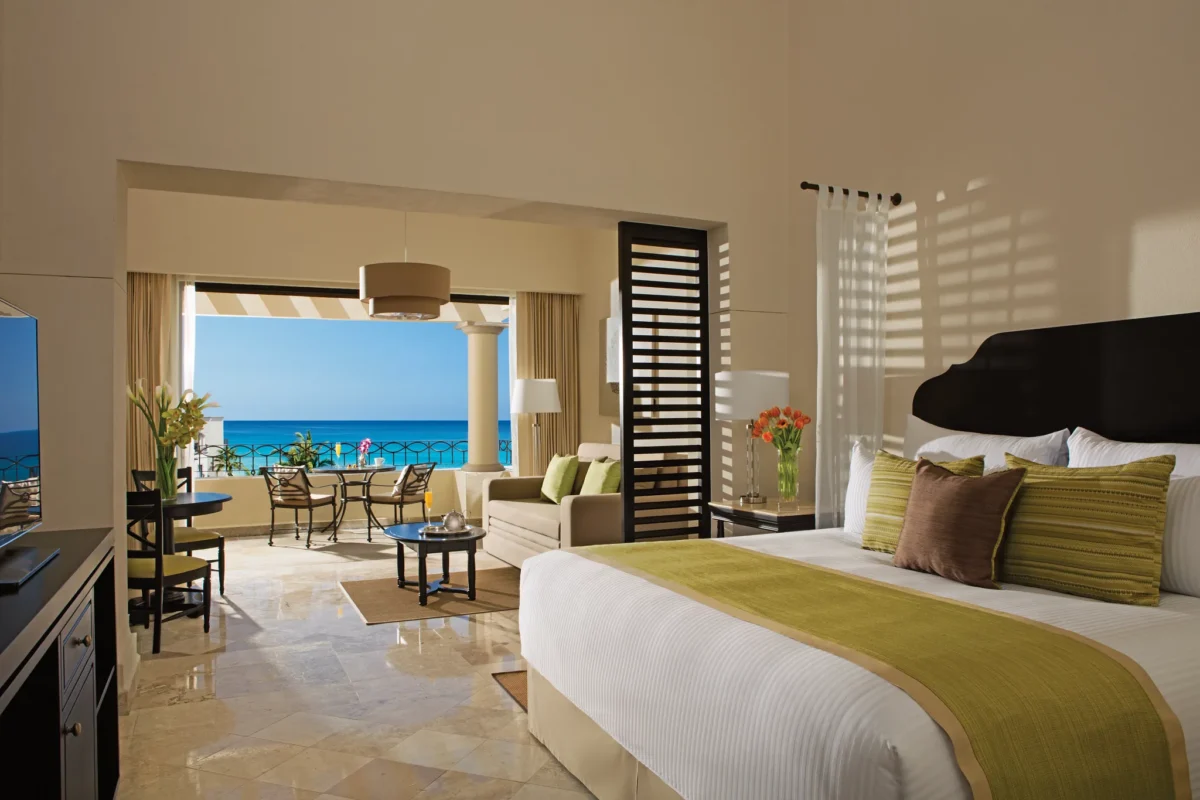 Preferred Club Junior Suite Ocean View with king bed, sitting area, and private balcony overlooking the Sea of Cortez at Dreams Los Cabos Suites Golf Resort & Spa.