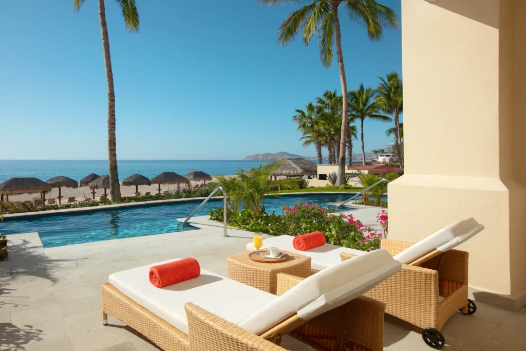 Preferred Club Junior Suite Oceanfront Swim Out terrace loungers beside pool with beach and ocean views at Dreams Los Cabos Suites Golf Resort & Spa.