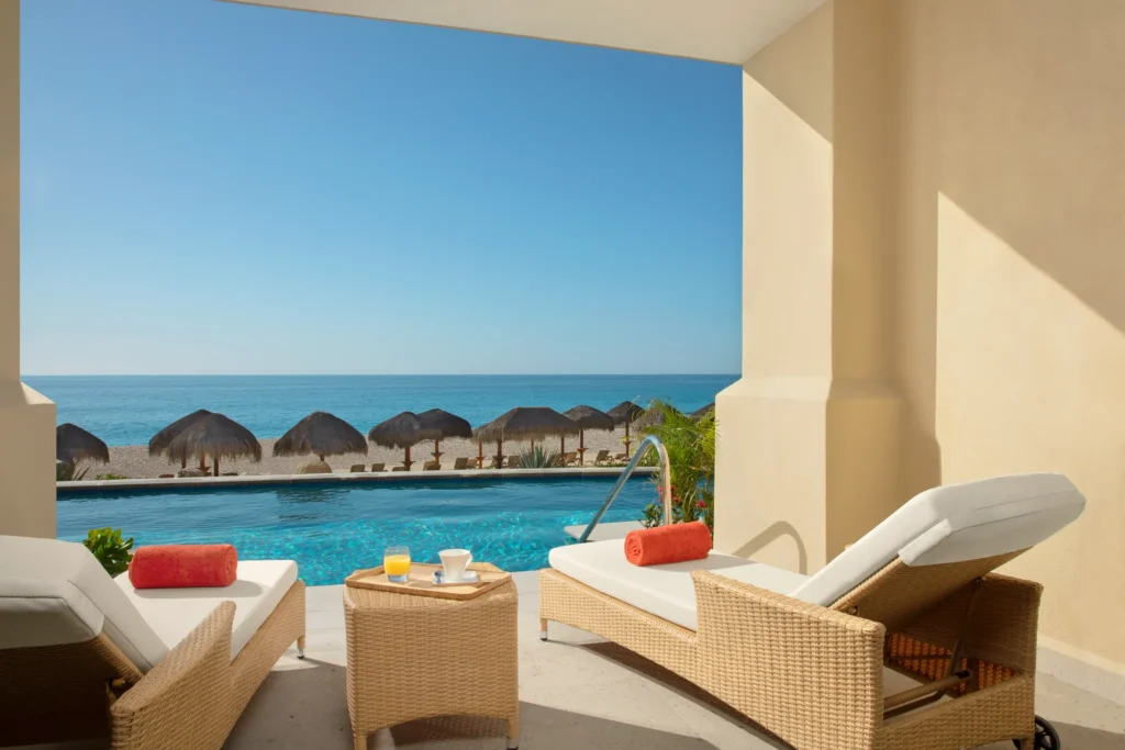Preferred Club Junior Suite Oceanfront Swim Out terrace with lounge chairs and pool overlooking the Sea of Cortez at Dreams Los Cabos.
