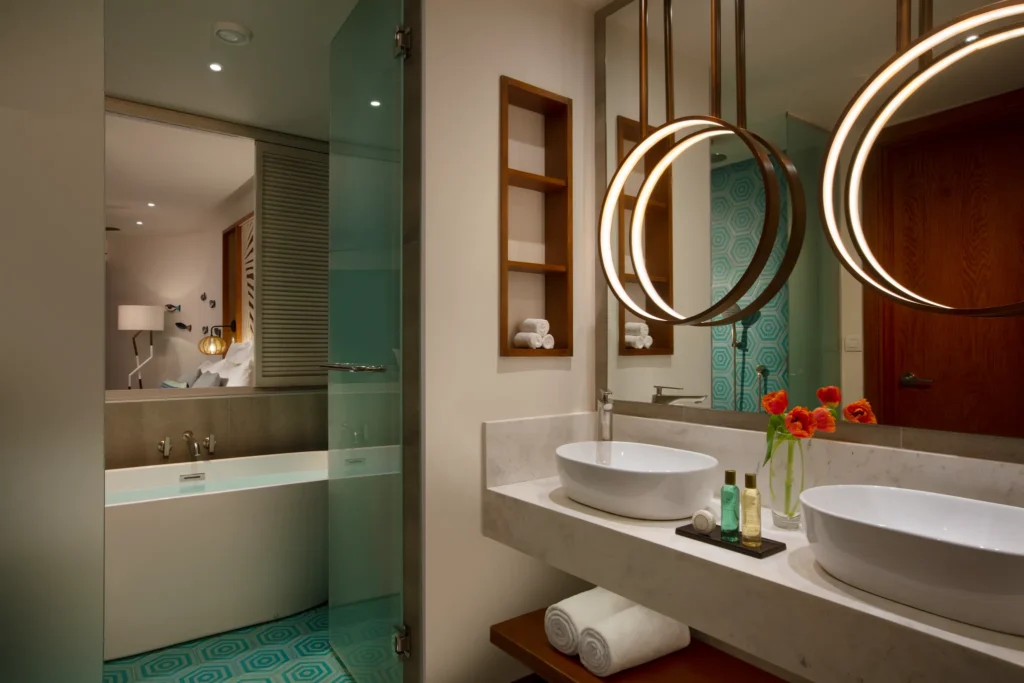 Junior Suite Ocean View bathroom with dual vessel sinks and modern rain shower at Dreams Macao Beach Punta Cana.