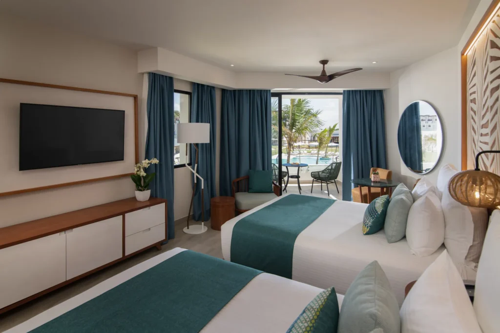 Junior Suite Pool View with two queen beds and furnished balcony at Dreams Macao Beach Punta Cana.