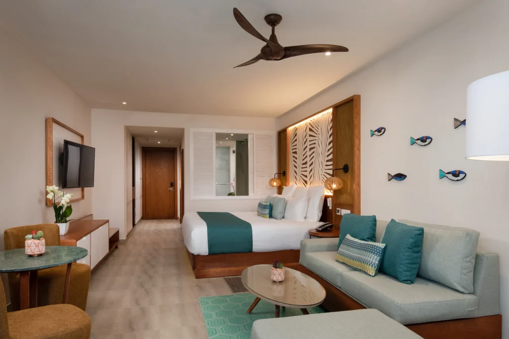 Junior Suite Tropical View with king bed and living area at Dreams Macao Beach Punta Cana.