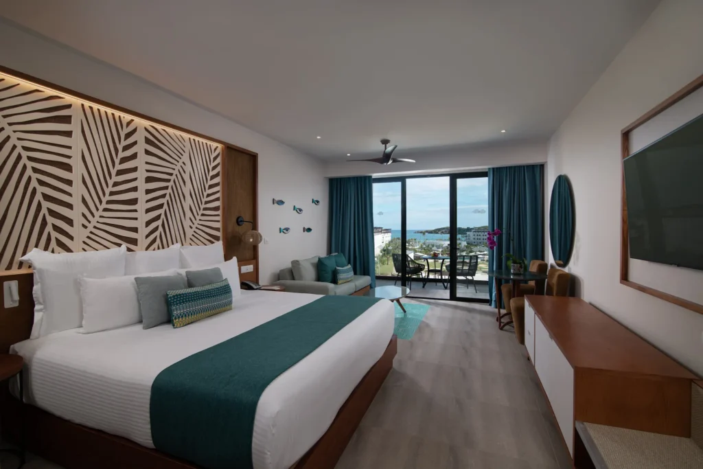 Preferred Club Junior Suite Ocean View with king bed and furnished balcony at Dreams Macao Beach Punta Cana.
