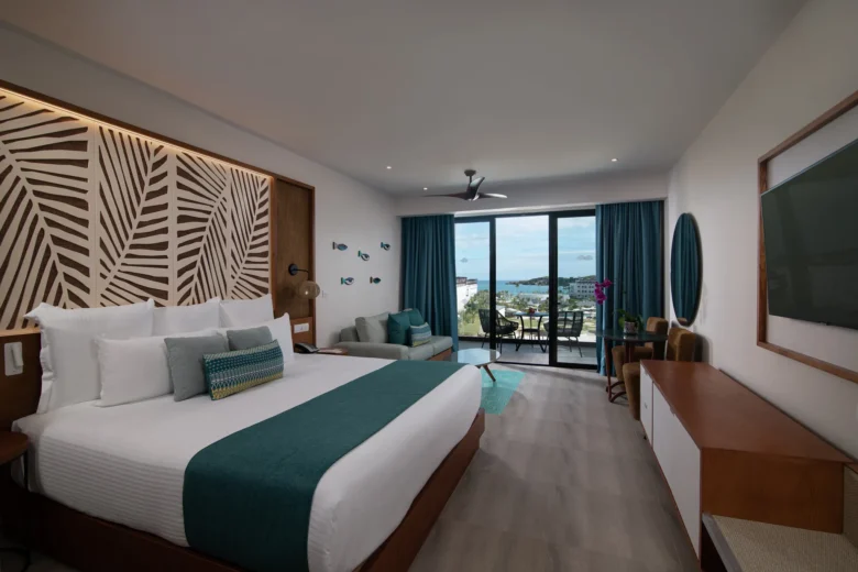 Preferred Club Junior Suite Ocean View with king bed and furnished balcony at Dreams Macao Beach Punta Cana.