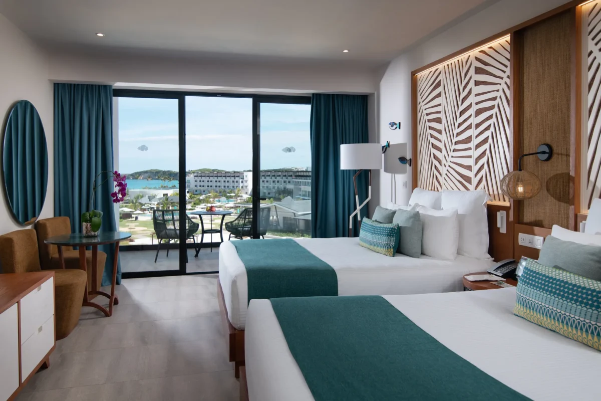 Preferred Club Junior Suite Partial Ocean View with two queen beds and balcony at Dreams Macao Beach Punta Cana.
