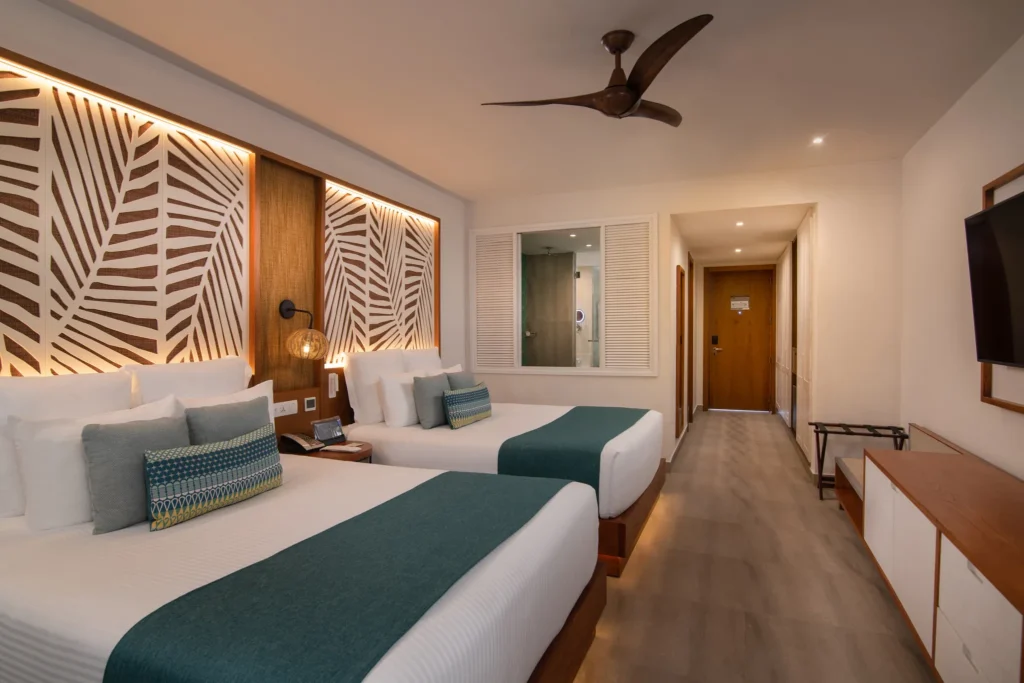 Preferred Club Junior Suite Tropical View with two double beds at Dreams Macao Beach Punta Cana.