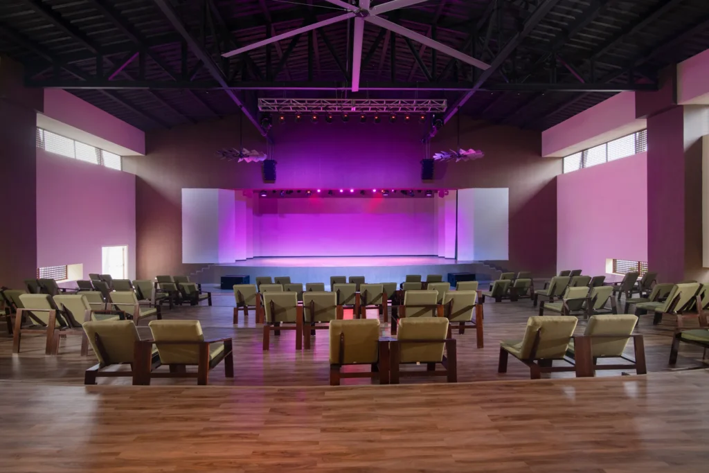 Indoor performance theater with stage lighting and lounge seating at Dreams Macao Beach Punta Cana.