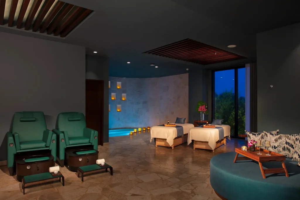 Couples massage treatment room with soft lighting and relaxation area at Dreams Natura Resort & Spa.