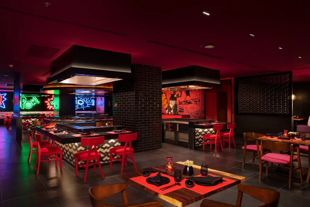 Himitsu Pan-Asian restaurant at Dreams Natura Resort & Spa featuring hibachi tables, teppanyaki cooking, and elegant Asian-inspired décor.