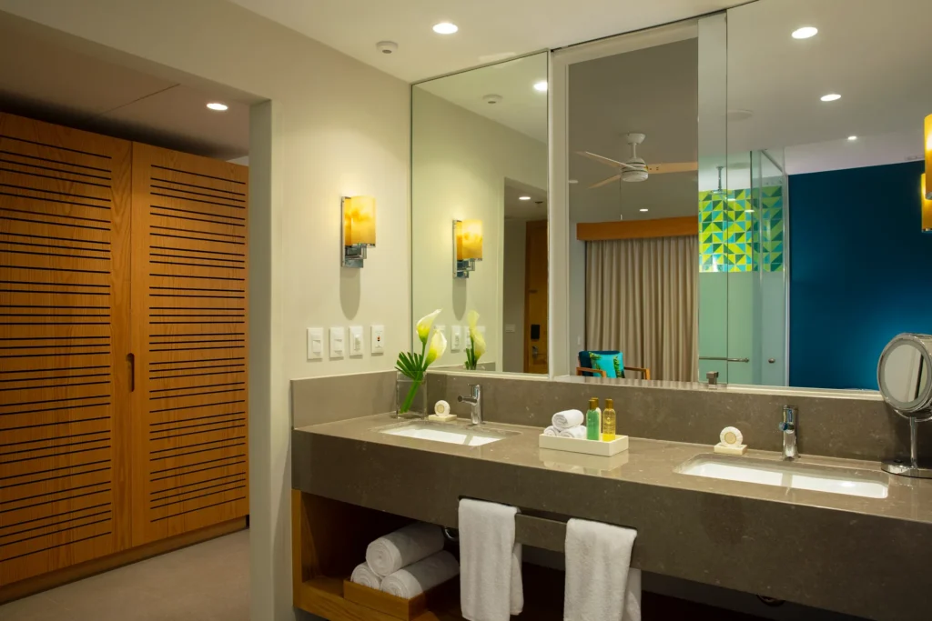 Junior Suite Partial Ocean View bathroom with double vanity and modern lighting at Dreams Natura Resort & Spa.