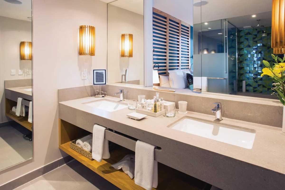 Preferred Club Junior Suite Ocean View bathroom with double sinks and large mirror at Dreams Natura Resort & Spa.