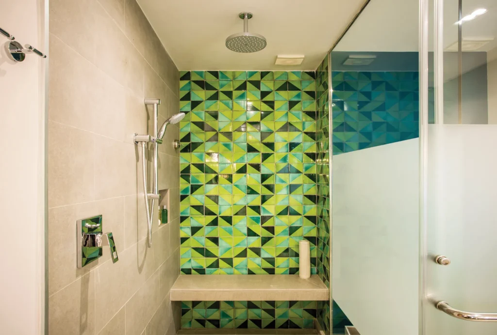 Preferred Club Junior Suite Ocean View walk-in shower with rainfall showerhead and tile design at Dreams Natura Resort & Spa.