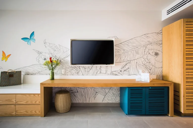 Preferred Club Junior Suite Ocean View workspace with TV and modern furnishings at Dreams Natura Resort & Spa.