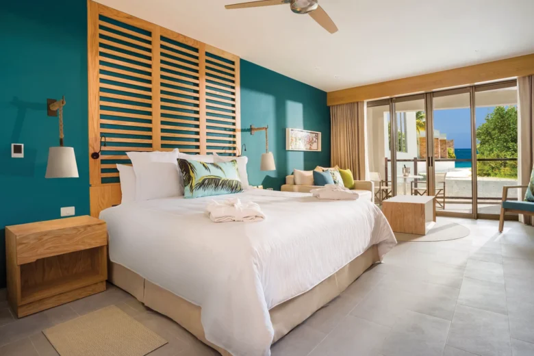 Preferred Club Junior Suite Partial Ocean View with king bed and balcony at Dreams Natura Resort & Spa.