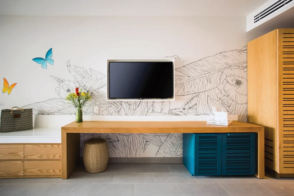Preferred Club Junior Suite Swim Out workspace with TV and modern décor at Dreams Natura Resort & Spa.