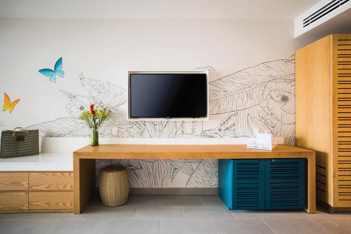Preferred Club Junior Suite Swim Out workspace with TV and modern décor at Dreams Natura Resort & Spa.