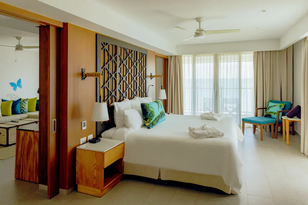Preferred Club Master Suite Ocean View bedroom with balcony access and ocean view at Dreams Natura Resort & Spa.
