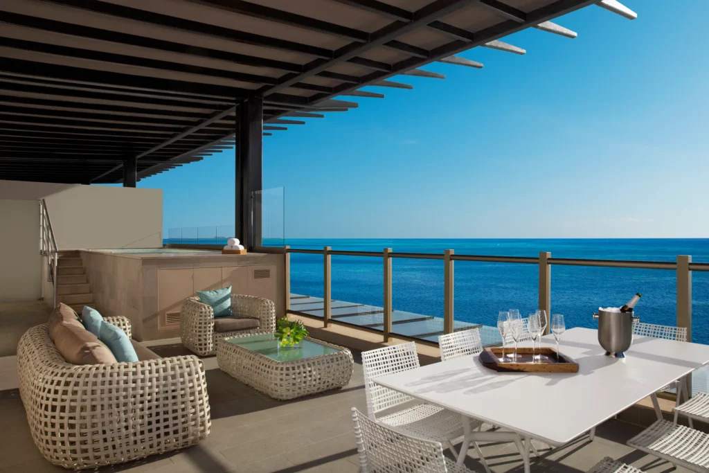 Preferred Club Presidential Suite terrace with outdoor dining and ocean view at Dreams Natura Resort & Spa.