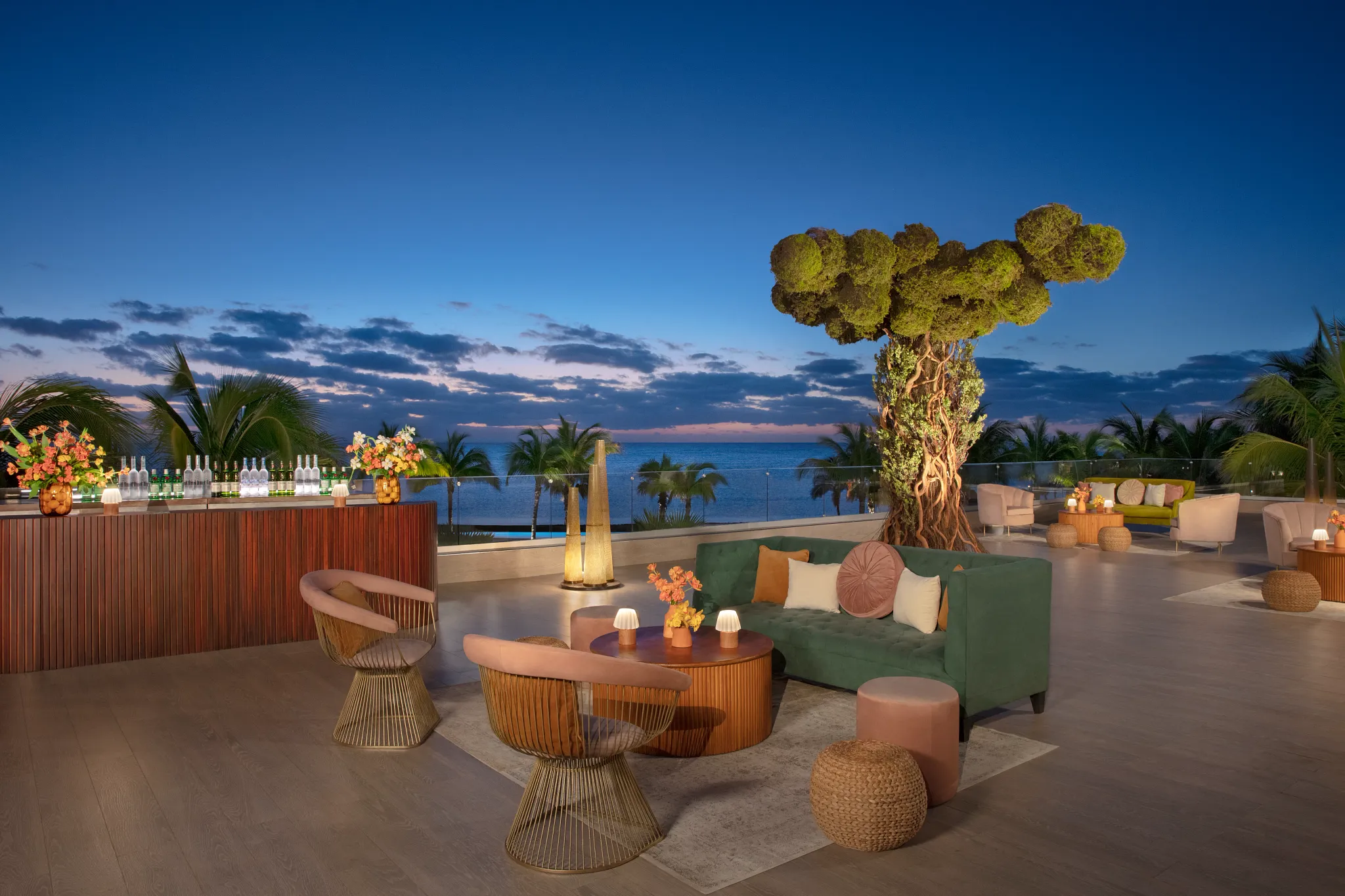 Rooftop terrace lounge setup with sunset ocean views at Dreams Natura Resort & Spa