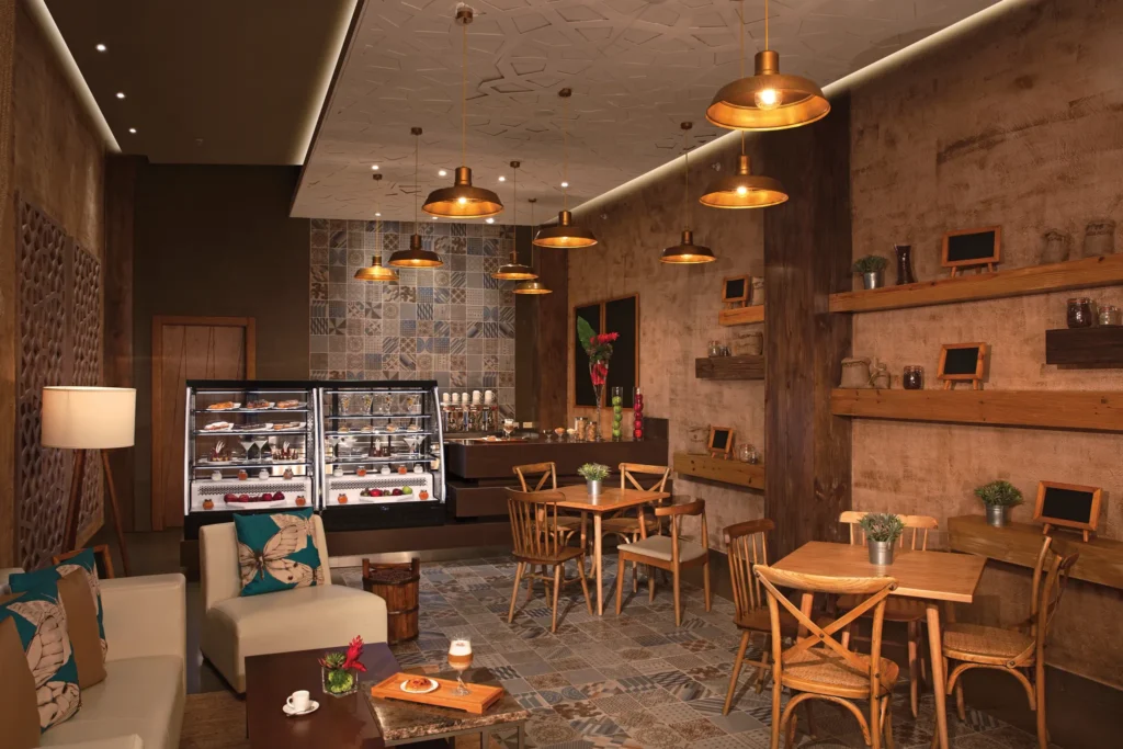 Coco Café at Dreams Onyx Resort & Spa featuring a cozy coffee shop atmosphere, premium coffee drinks, pastries, and casual seating.