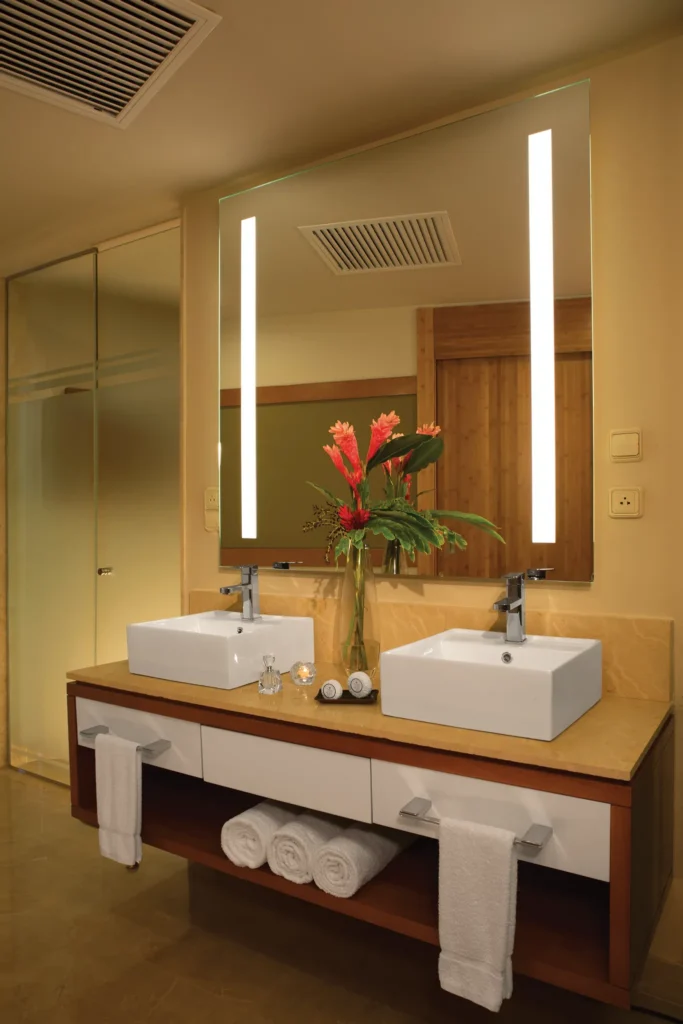 Dreams Onyx Resort Junior Suite bathroom with double vanity and illuminated mirror.
