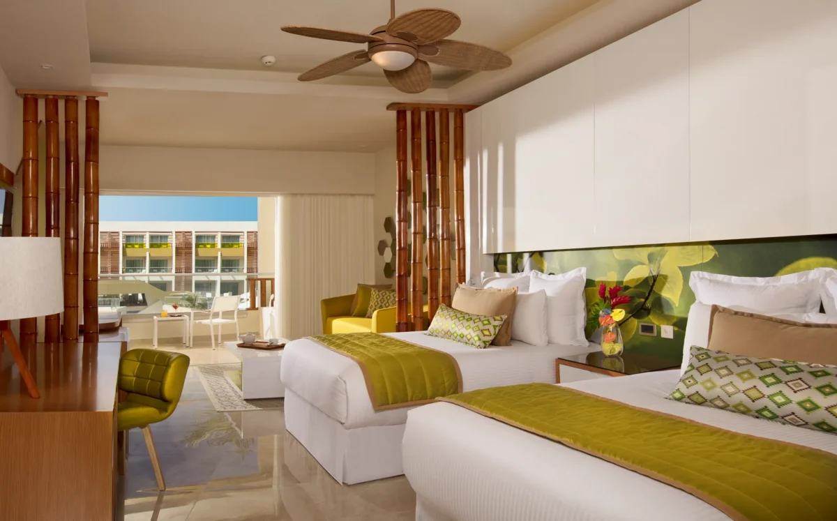 Junior Suite Garden View with two double beds and seating area at Dreams Onyx Resort & Spa.