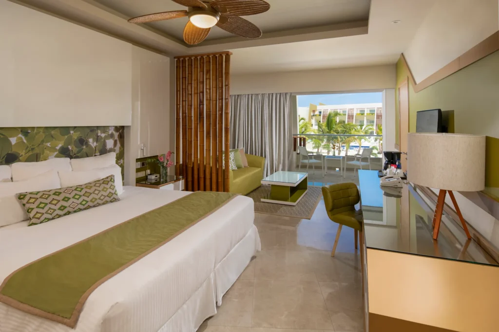 Junior Suite Garden View with king bed and sitting area at Dreams Onyx Resort & Spa Punta Cana.