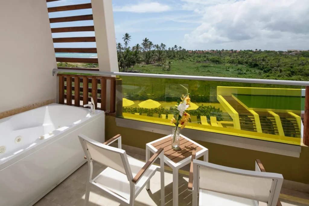 Junior Suite Garden View balcony with hot tub and tropical landscape views at Dreams Onyx Resort & Spa.