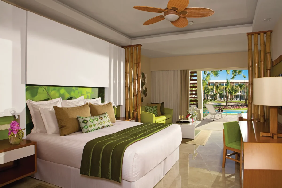 Junior Suite Swim-Up with king bed, sofa, and direct pool access terrace at Dreams Onyx Resort & Spa.