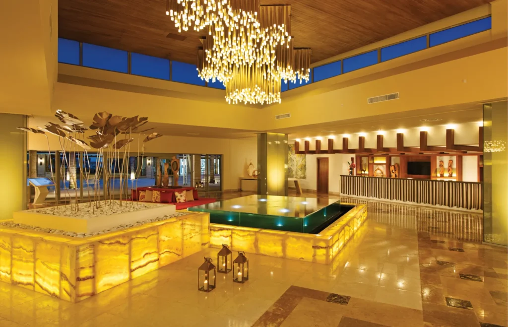 Elegant resort lobby with chandelier and water feature at Dreams Onyx Resort & Spa in Punta Cana.