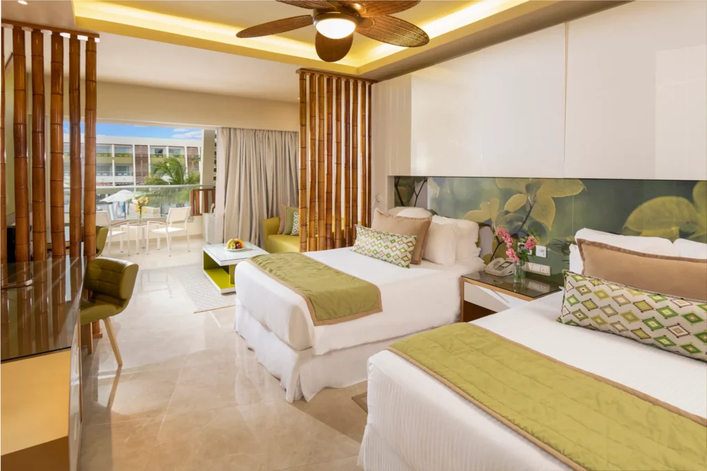 Preferred Club Junior Suite Pool View with two double beds and modern design at Dreams Onyx Resort & Spa.