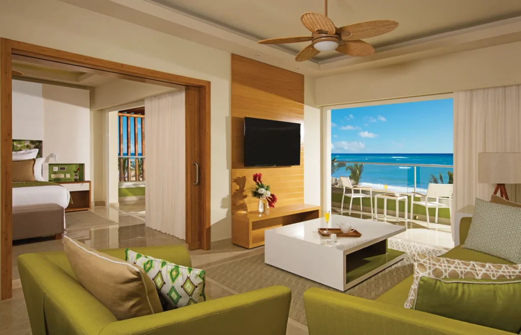 Living area with oceanfront balcony view in Preferred Club Master Suite at Dreams Onyx Resort & Spa.