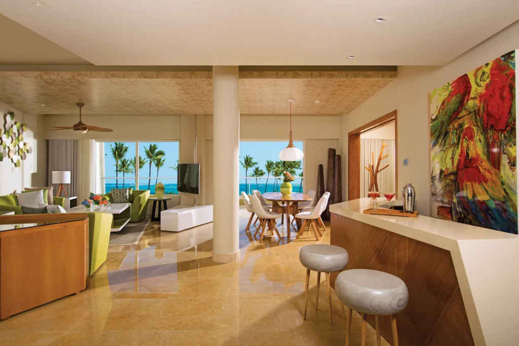 Living and dining area with ocean view in Preferred Club Presidential Suite at Dreams Onyx Resort & Spa.
