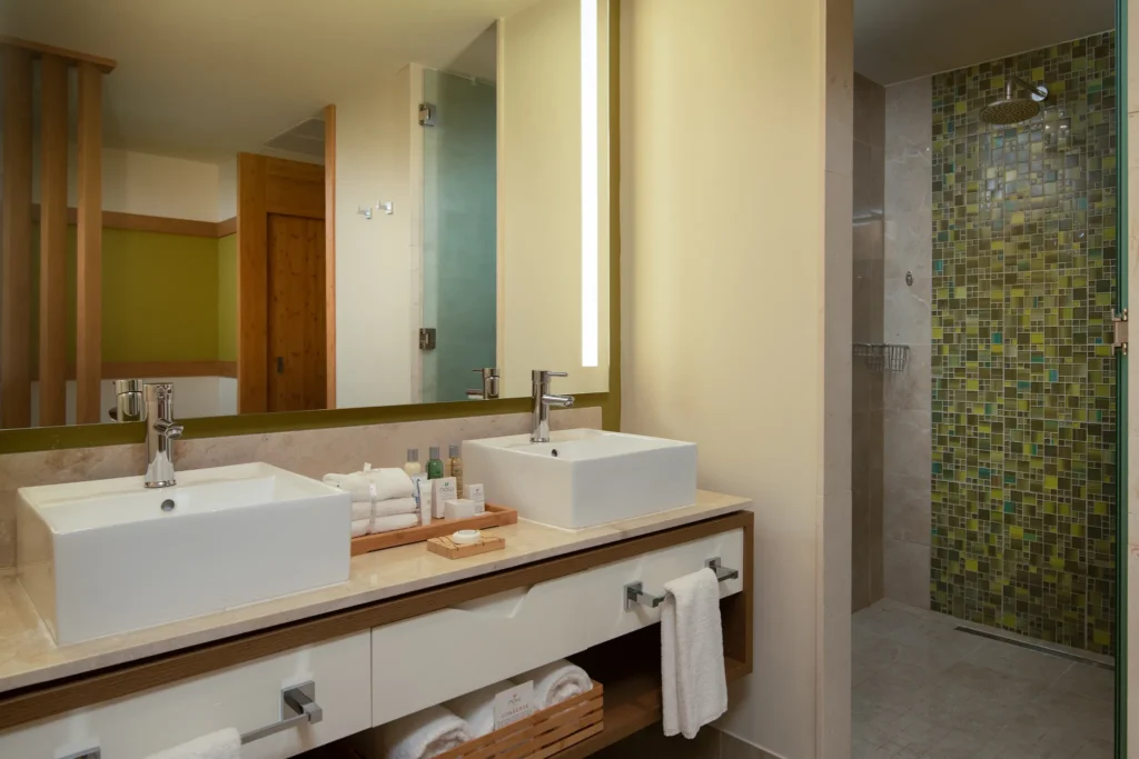 Premium Junior Suite bathroom with double sinks and rain shower at Dreams Onyx Resort & Spa.
