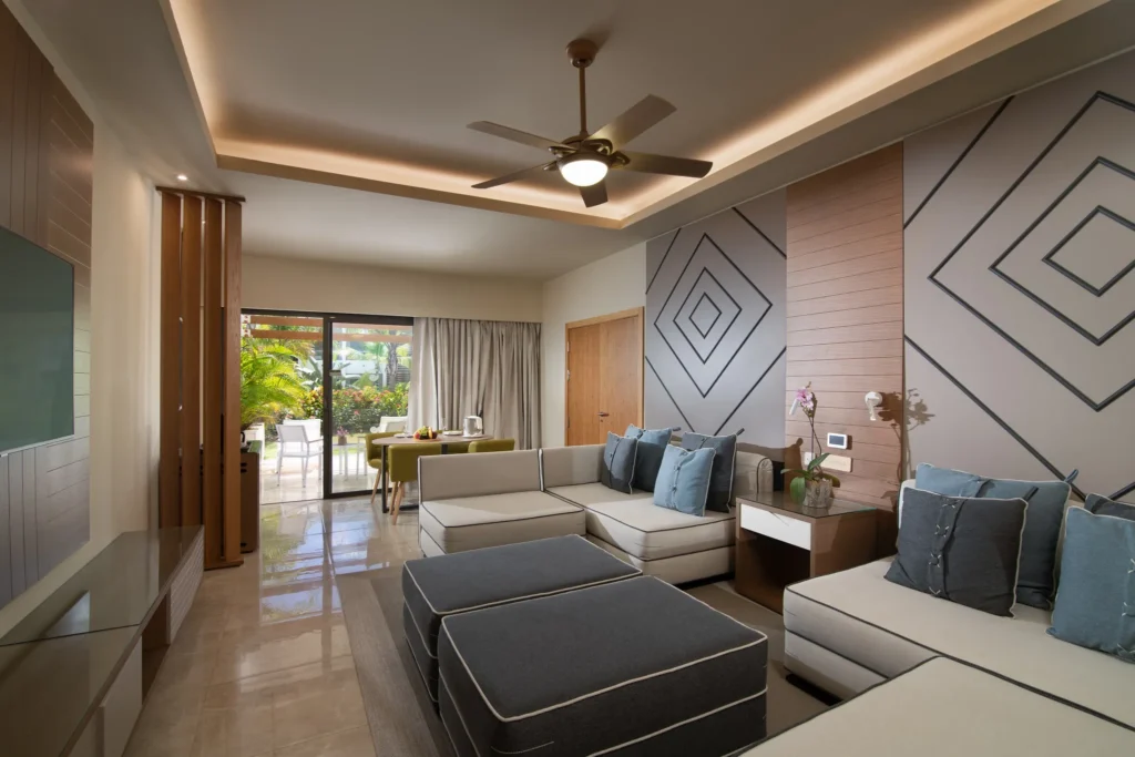 Two Bedroom Family Suite living room with sectional sofa and terrace access at Dreams Onyx Resort & Spa.