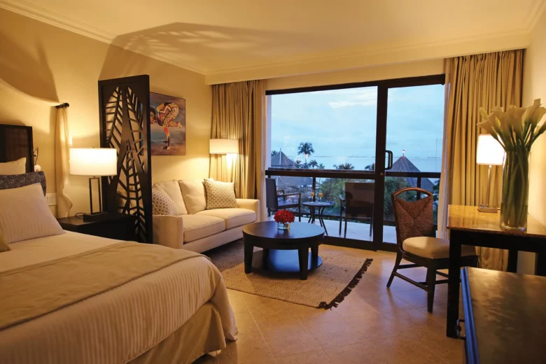 Deluxe Ocean View room with king bed and private balcony at Dreams Playa Bonita Panama overlooking the ocean.