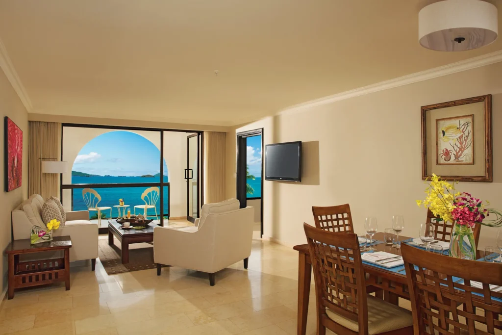 Preferred Club Master Suite Ocean View living and dining area with balcony at Dreams Playa Bonita Panama.