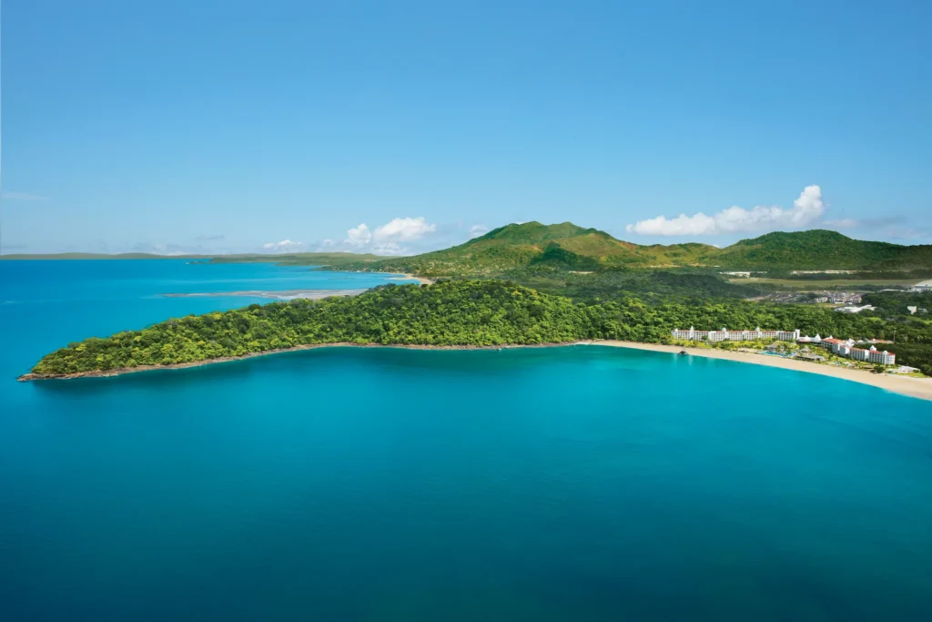 Wide aerial view of the secluded bay and beachfront at Dreams Playa Bonita Panama, surrounded by lush rainforest and turquoise waters.