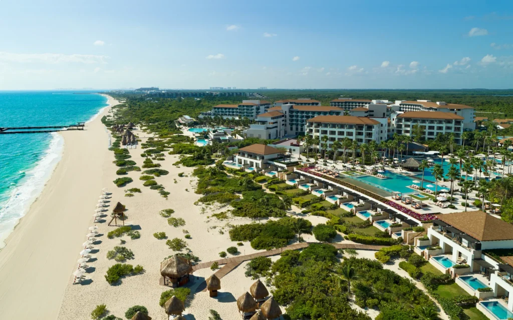 Aerial view of Dreams Playa Mujeres Resort with beachfront, pools, and white sand coastline in Cancun.