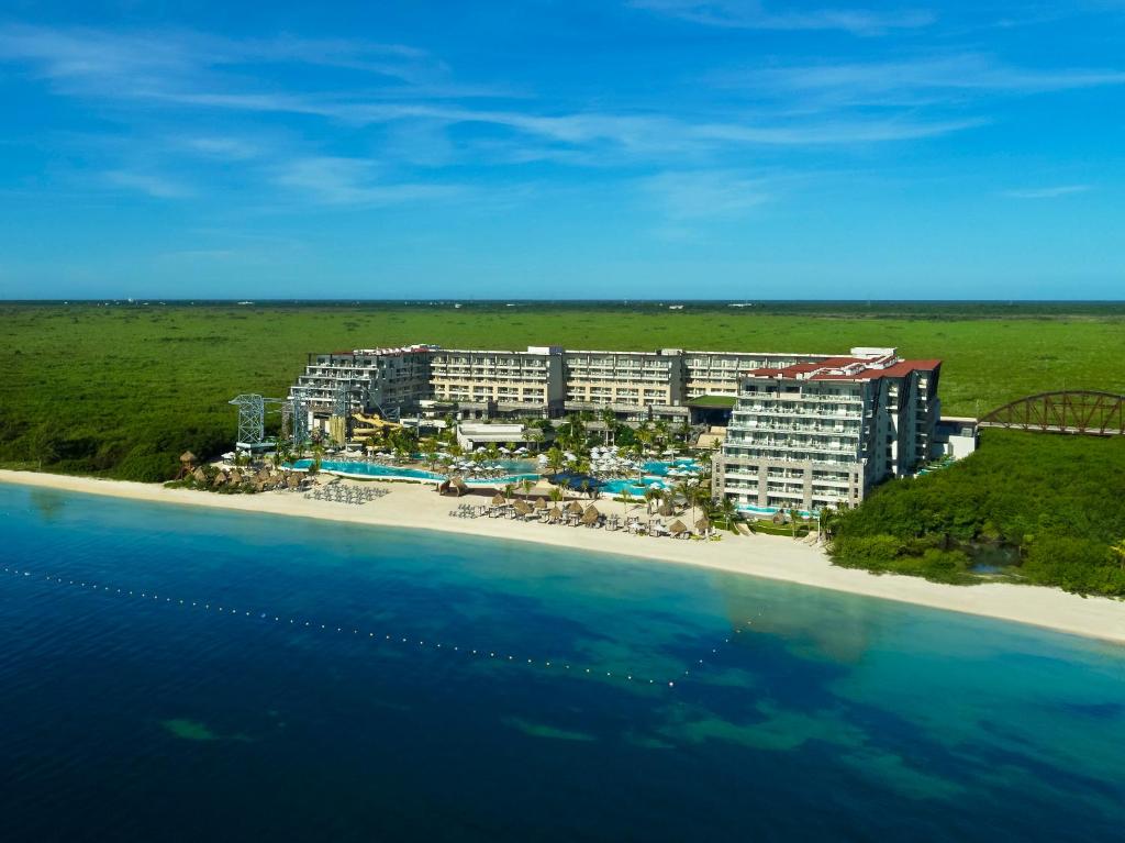 Dreams Natura Resort & Spa eco-friendly all-inclusive resort near Cancun with cenote-style pools, lush jungle setting, and nature experiences.
