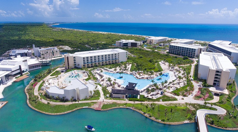 Grand Palladium Costa Mujeres Resort & Spa beachfront view with expansive pools and modern architecture near Cancun, Mexico.