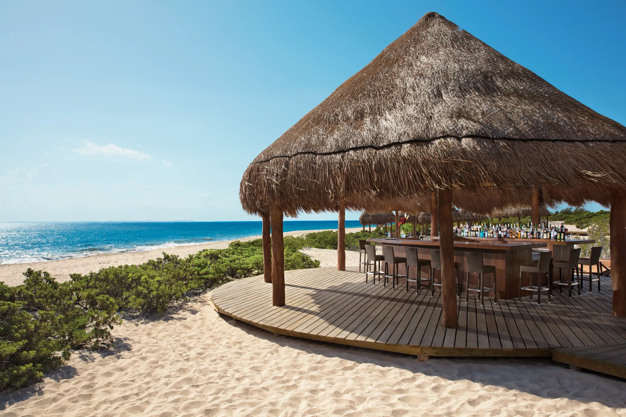 Hideaway beach bar at Dreams Playa Mujeres offering a quieter beach drinking spot in Playa Mujeres