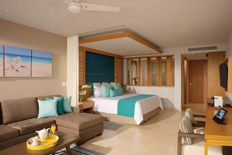 Junior Suite Ocean View with king bed and living area at Dreams Playa Mujeres Golf & Spa Resort.