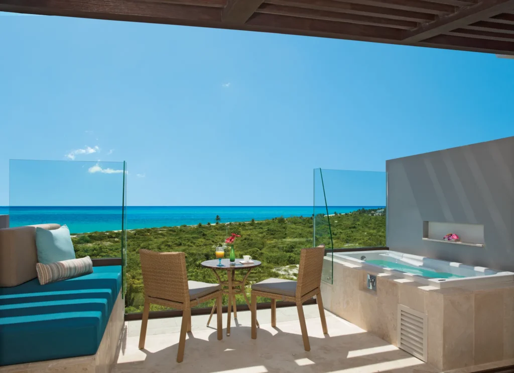 Junior Suite Ocean View terrace with hot tub and ocean views at Dreams Playa Mujeres Golf & Spa Resort.