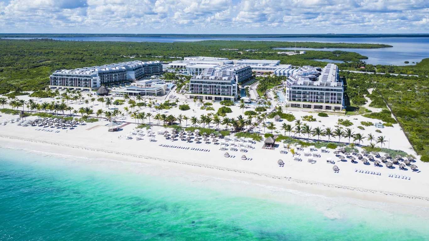 Majestic Elegance Costa Mujeres luxury all-inclusive resort with expansive pools, modern architecture, and beachfront setting near Cancun.