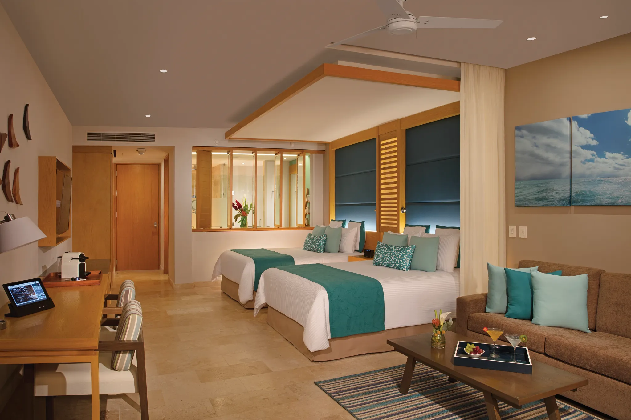 Junior suite bedroom with two queen beds and seating area.
