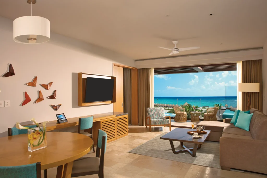 Living room with dining table and ocean view terrace access.