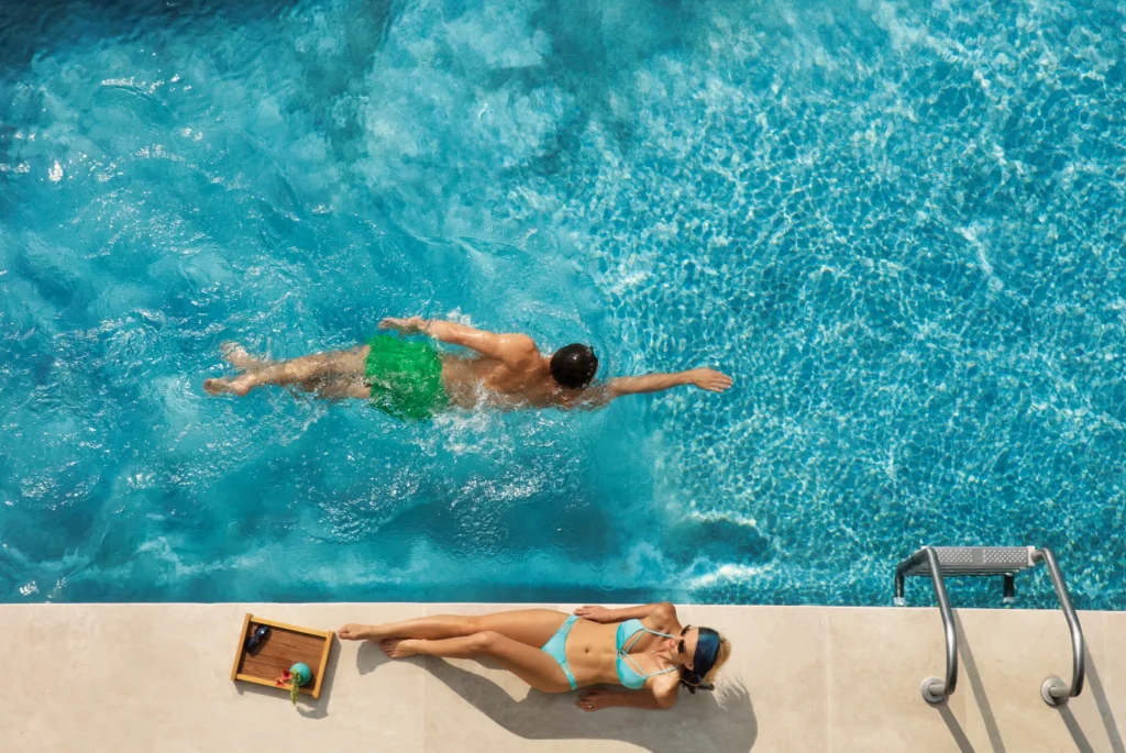 Guest swimming in semi-private pool at Preferred Club Junior Suite Swim Out Ocean View at Dreams Playa Mujeres.