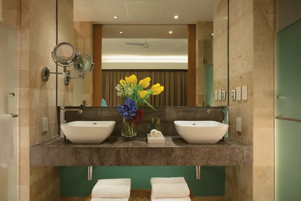 Bathroom with double sinks, large mirror, and modern finishes.