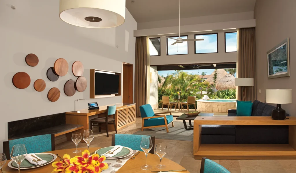 Spacious villa living area with dining table and terrace hot tub view.